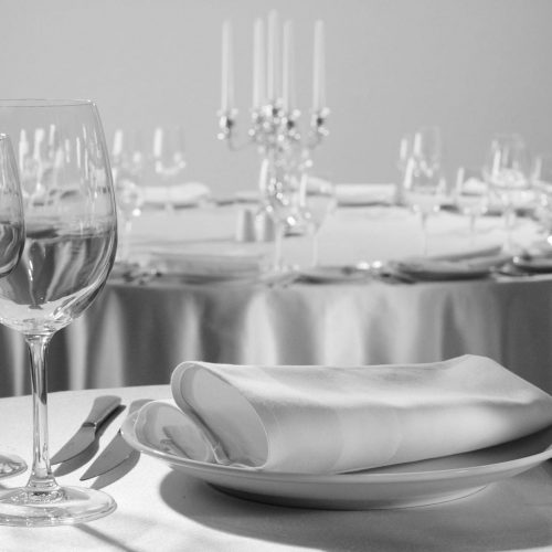 Served table in the restaurant - clean glasses, plates, forks, napkin